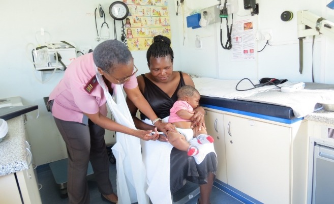 Nurse vaccinating a baby at a clinic.